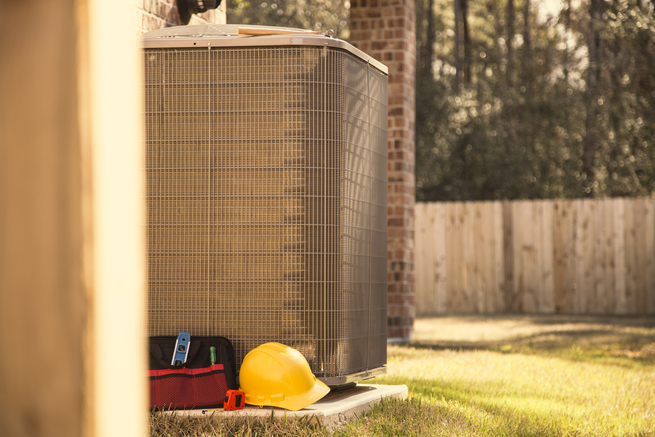 Air conditioner unit in summer with tools and toolbox.