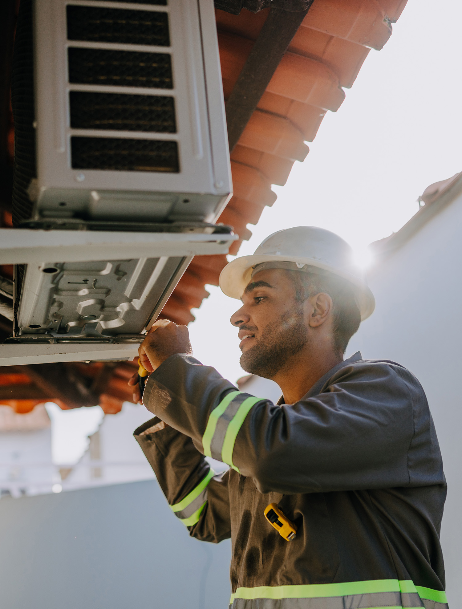 HVAC technician checks AC unit